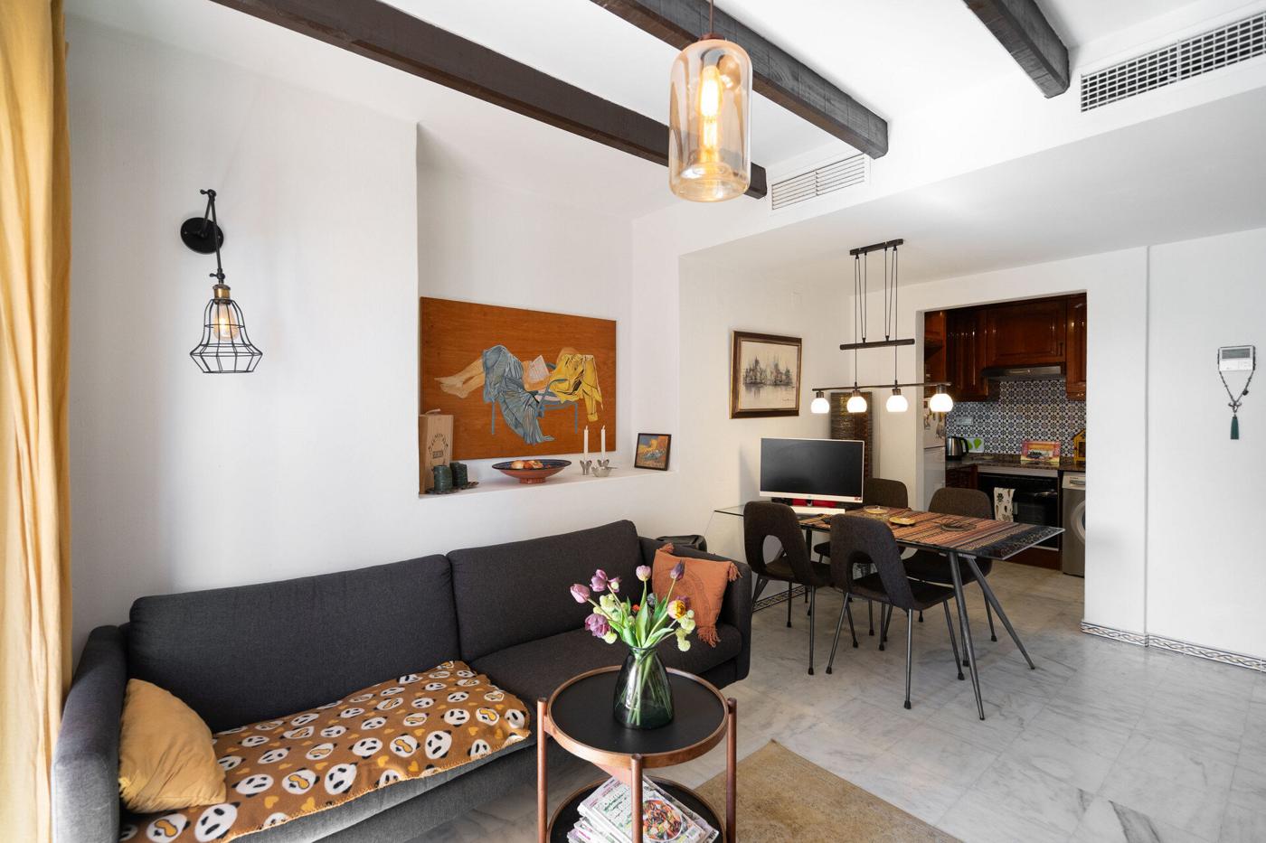 Living room with sofa, dining table and kitchen beyond